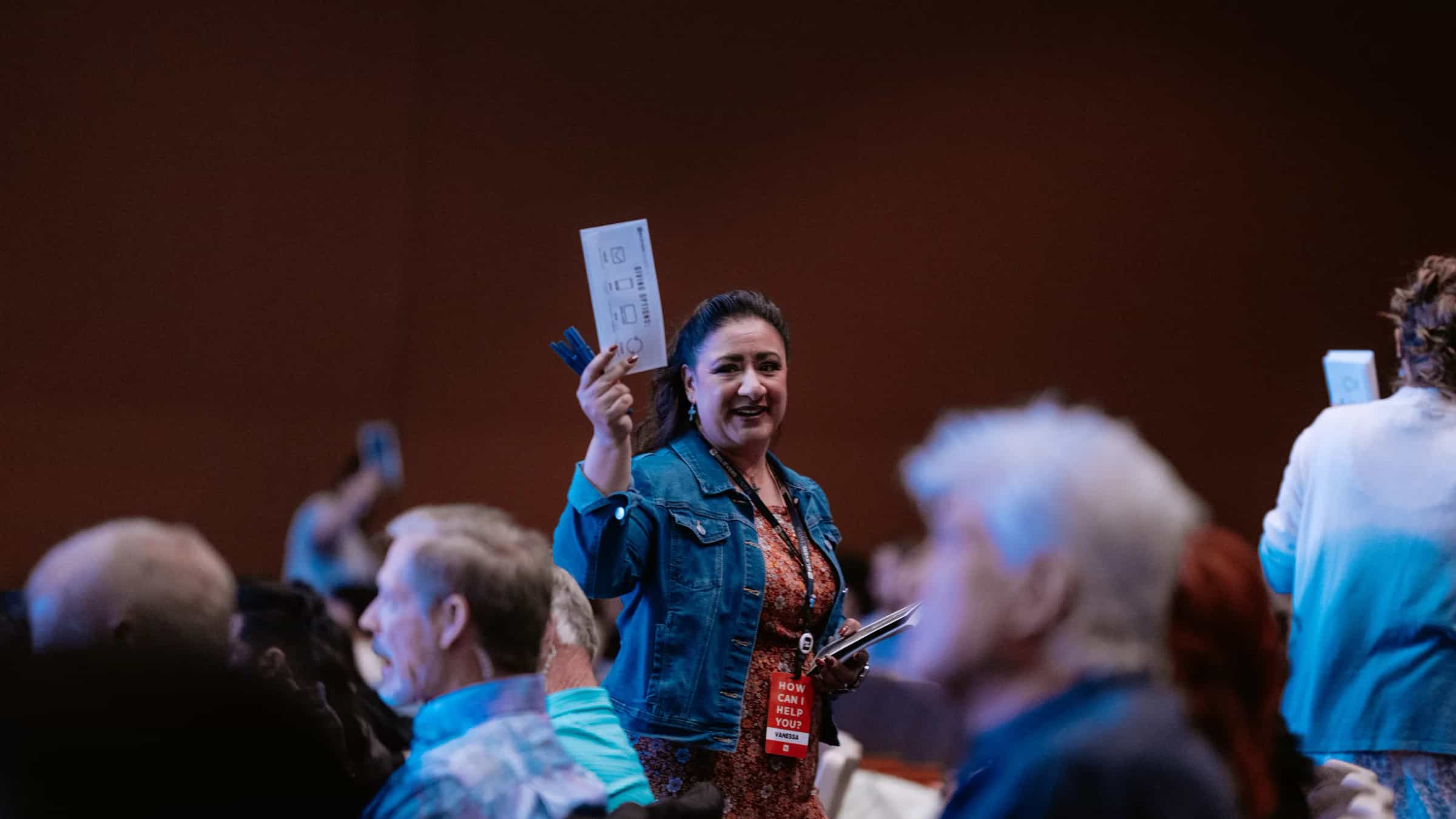 Serve team member greeting people during a Believer Church gathering