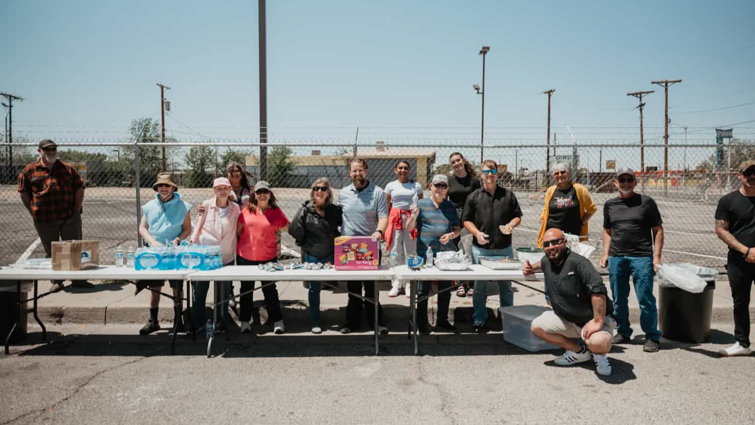Love ABQ serve team standing behind tables of food and water